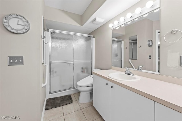 bathroom with toilet, vanity, walk in shower, and tile patterned flooring