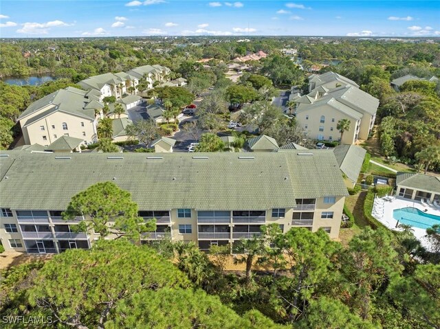 15495 Cedarwood Ln Unit 103, Naples, FL 34110 - aerial perspective of suburban area with a pool area and a tree filled landscape