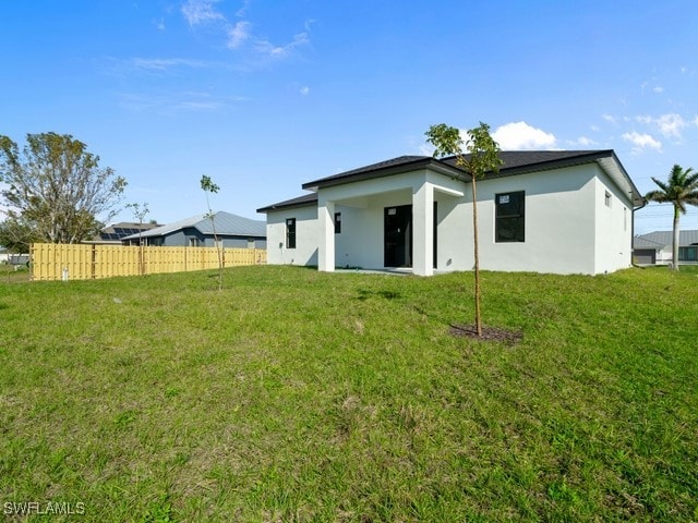 rear view of house with a lawn