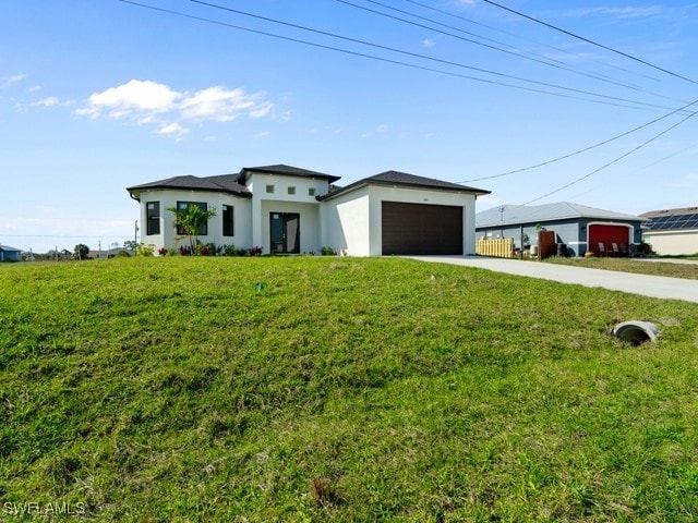 view of front of home featuring a front yard and a garage