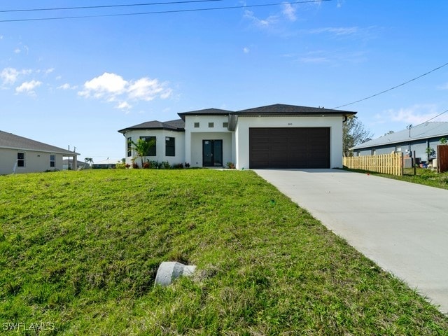 view of front of house with a front yard and a garage