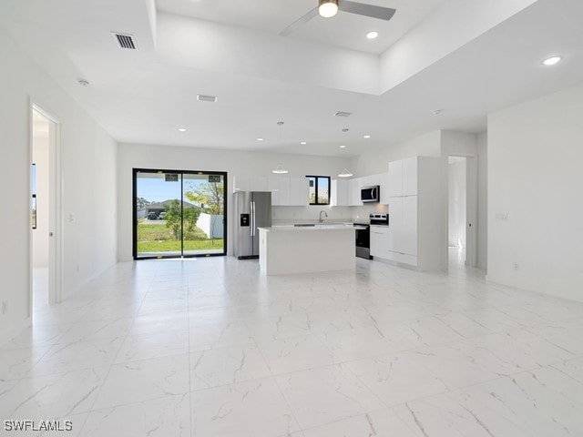 unfurnished living room featuring ceiling fan