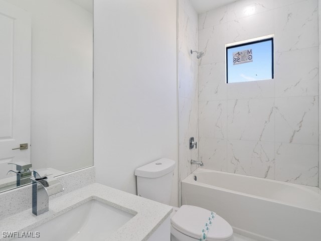 full bathroom featuring tiled shower / bath combo, vanity, and toilet