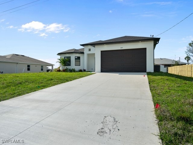 view of front of property with a front lawn and a garage