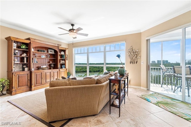 living room featuring ceiling fan, a water view, and crown molding