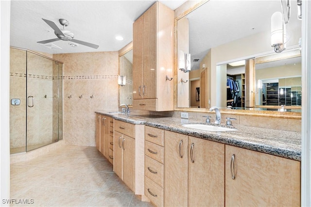 bathroom featuring an enclosed shower, tile patterned floors, vanity, tile walls, and ceiling fan