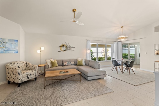 tiled living room featuring ceiling fan with notable chandelier