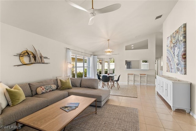 living room featuring lofted ceiling, ceiling fan with notable chandelier, and light tile patterned floors