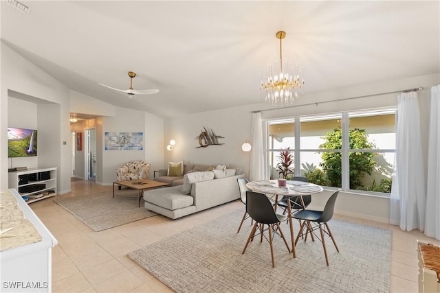 tiled dining area featuring vaulted ceiling and ceiling fan with notable chandelier