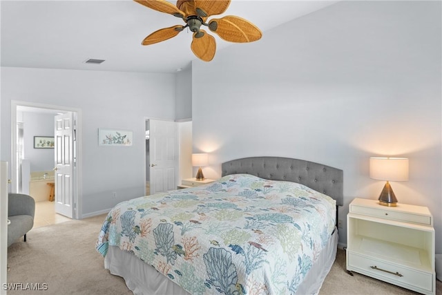 carpeted bedroom with ceiling fan and connected bathroom