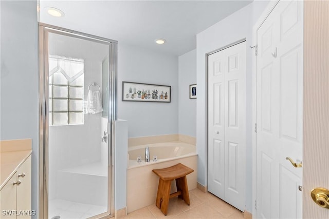 bathroom with separate shower and tub, vanity, and tile patterned floors