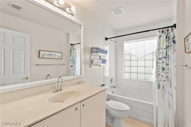 full bathroom featuring tile patterned floors, shower / tub combo with curtain, vanity, and toilet