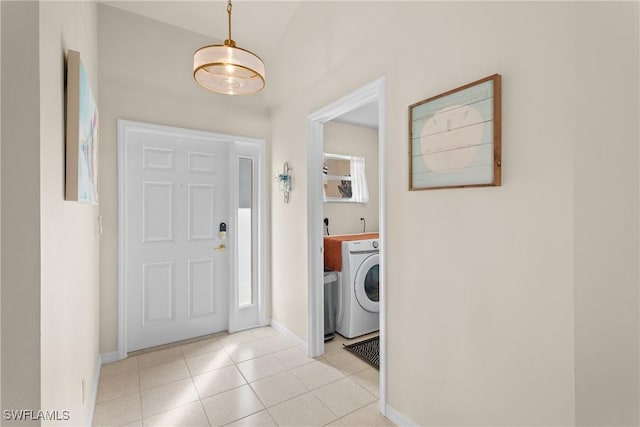 laundry room with washer / dryer and light tile patterned floors