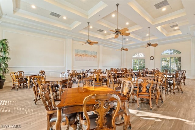 dining room with beam ceiling, light wood-type flooring, and coffered ceiling