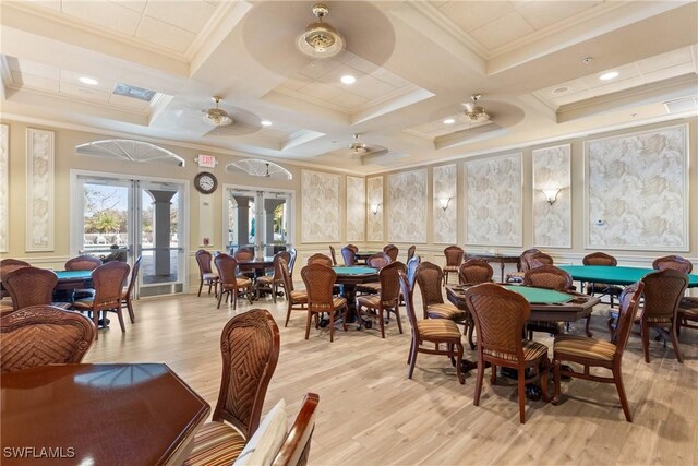 dining area featuring coffered ceiling, french doors, light wood-type flooring, ceiling fan, and beamed ceiling