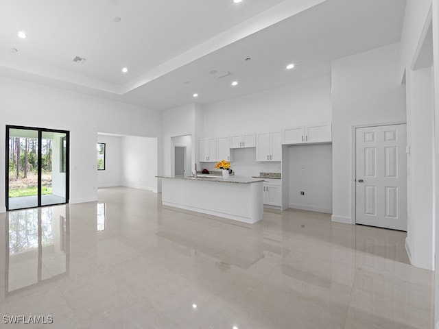 unfurnished living room with a high ceiling