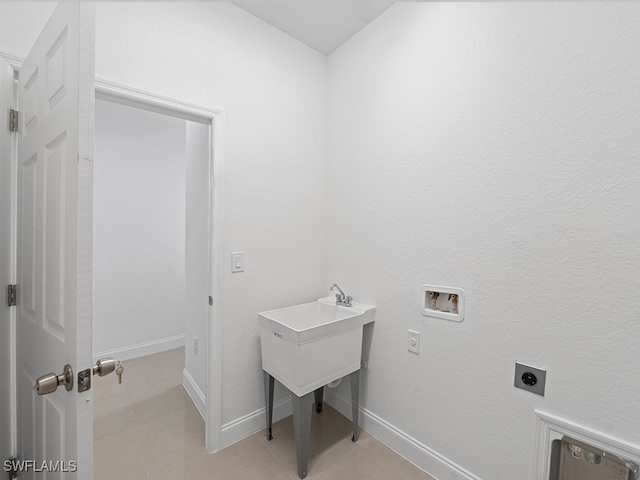 laundry area with hookup for a washing machine, light tile patterned flooring, and hookup for an electric dryer