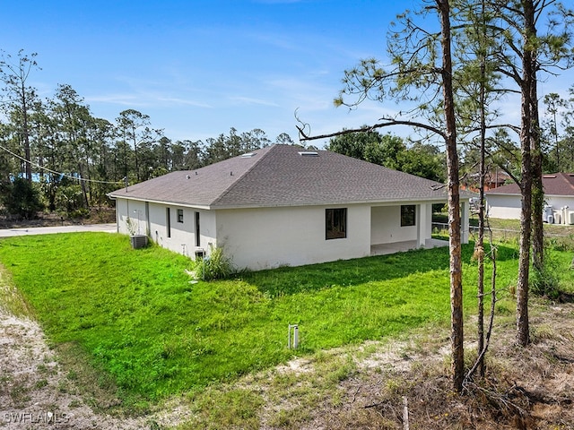 view of property exterior featuring a lawn and central AC unit