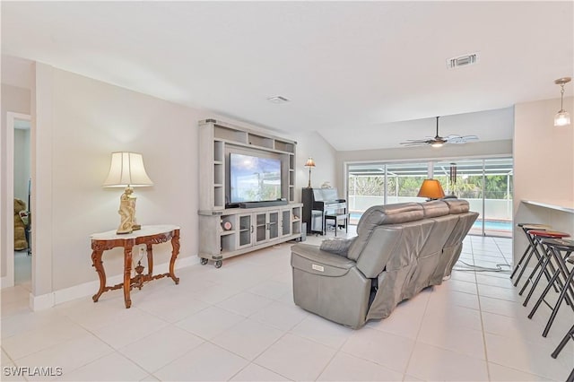 tiled living room with lofted ceiling and ceiling fan