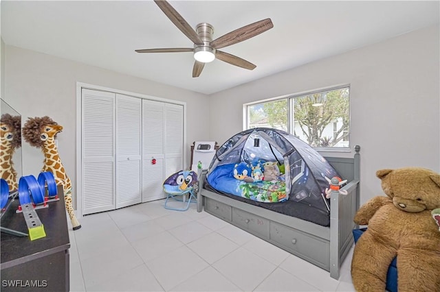 tiled bedroom featuring a closet and ceiling fan