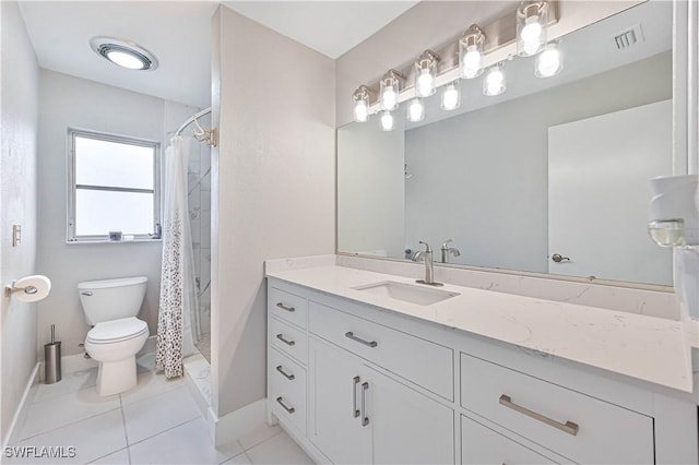 bathroom featuring toilet, vanity, a shower with curtain, and tile patterned flooring