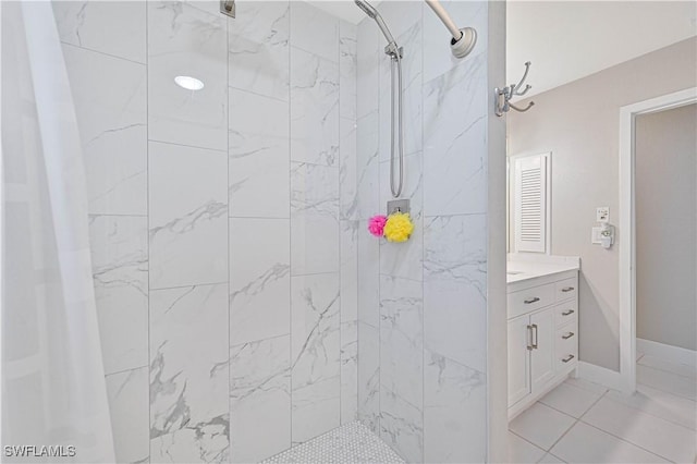 bathroom with tile patterned flooring, walk in shower, and vanity