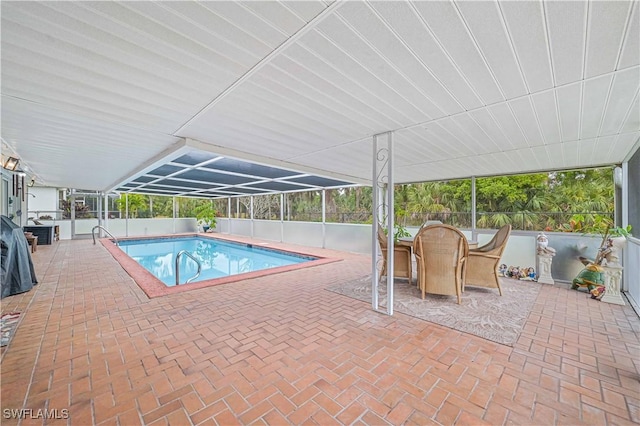 view of pool featuring glass enclosure and a patio