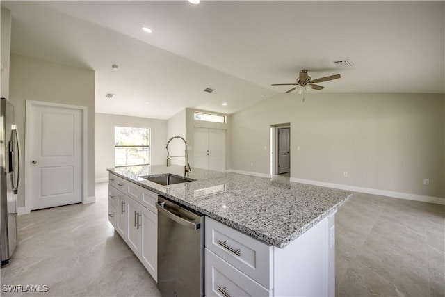 kitchen featuring light stone countertops, white cabinetry, stainless steel appliances, sink, and ceiling fan