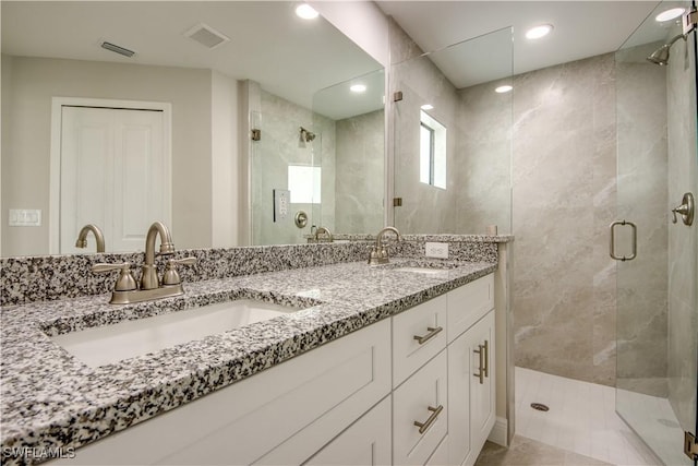 bathroom with an enclosed shower and vanity