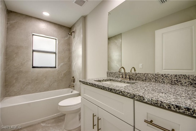 full bathroom featuring toilet, tiled shower / bath combo, tile patterned floors, and vanity