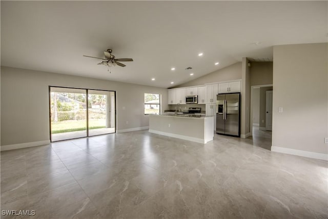 unfurnished living room featuring ceiling fan, sink, and high vaulted ceiling