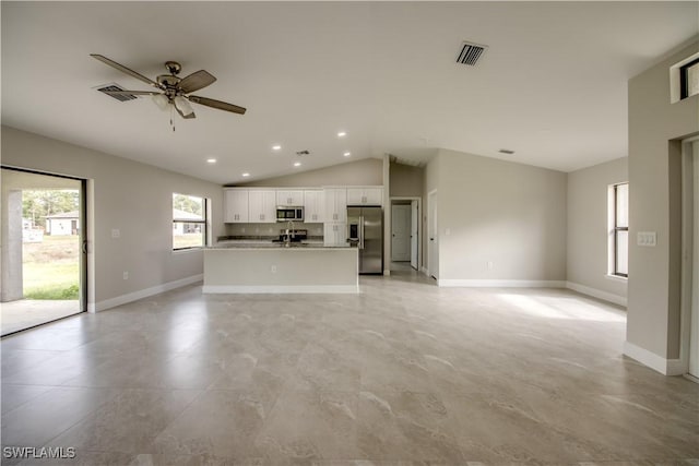 unfurnished living room with ceiling fan and lofted ceiling