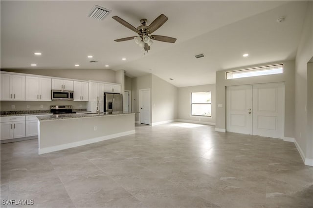 kitchen with white cabinetry, a center island with sink, ceiling fan, stainless steel appliances, and sink