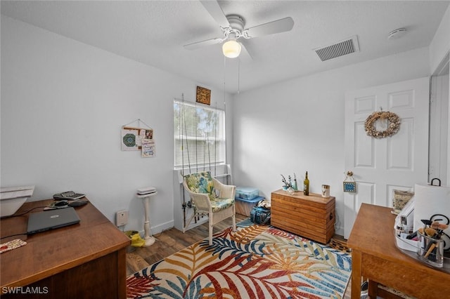 home office with ceiling fan and hardwood / wood-style flooring