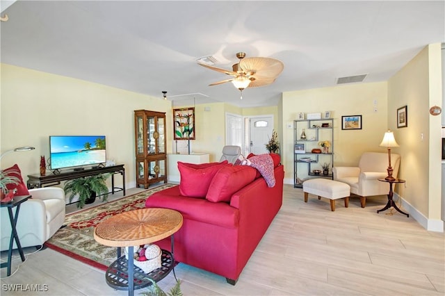 living room featuring ceiling fan and light hardwood / wood-style floors