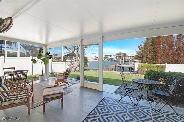 sunroom with plenty of natural light and a water view