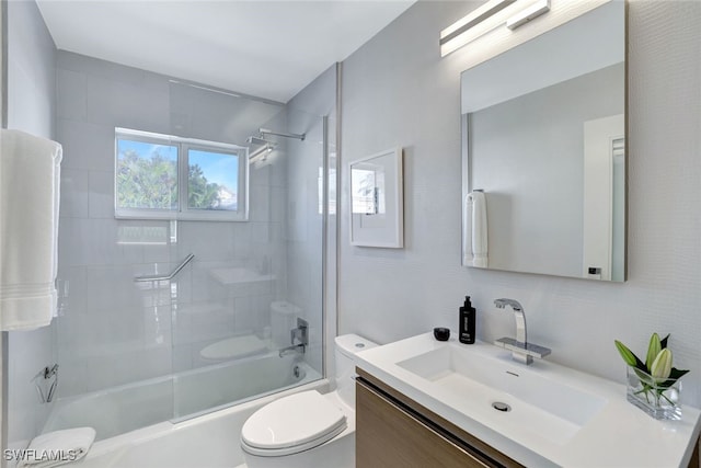 full bathroom featuring toilet, vanity, and bath / shower combo with glass door