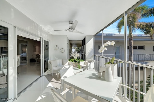 sunroom featuring ceiling fan