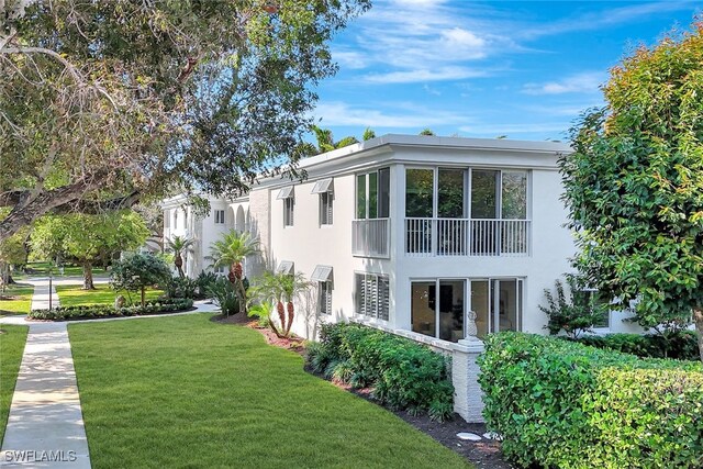 view of side of home with a lawn