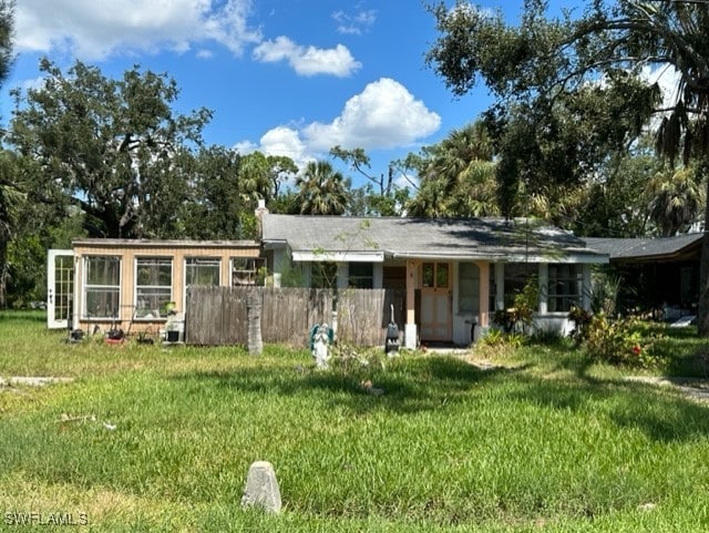 rear view of property with a yard