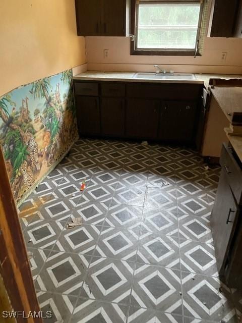 kitchen featuring dark brown cabinets and sink