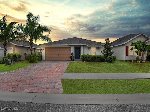 ranch-style house with a lawn and a garage