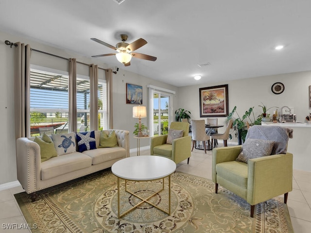 living room with ceiling fan and light tile patterned floors