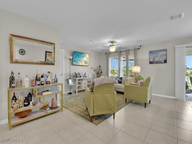 tiled living room with ceiling fan