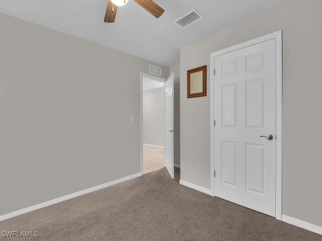 unfurnished bedroom featuring ceiling fan and light colored carpet