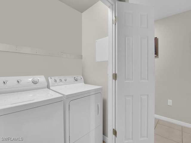 laundry room featuring independent washer and dryer and light tile patterned flooring