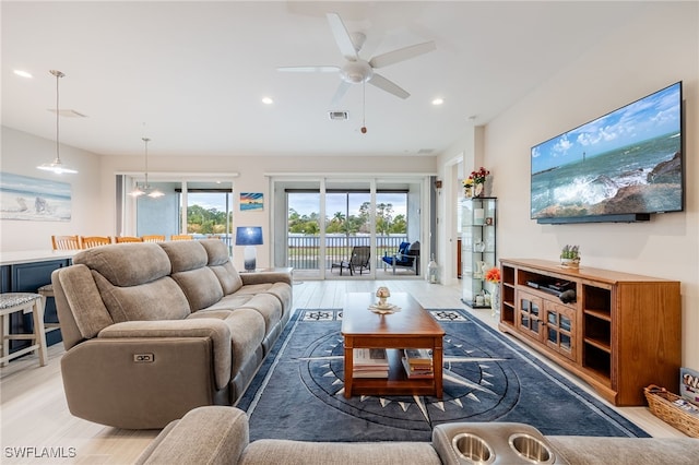 living room with ceiling fan and light hardwood / wood-style floors