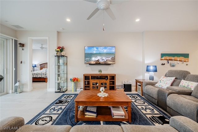 living room with ceiling fan and light wood-type flooring