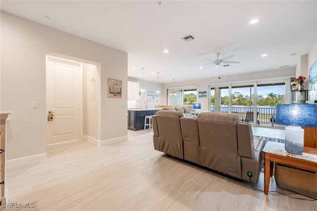 living room featuring ceiling fan and sink