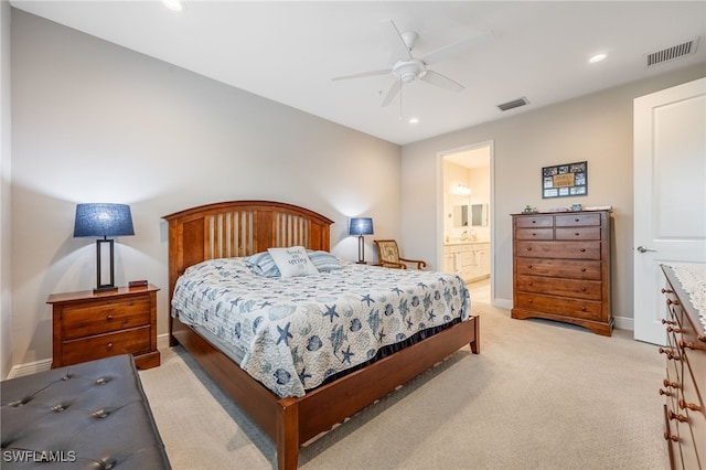 carpeted bedroom with ceiling fan and ensuite bathroom